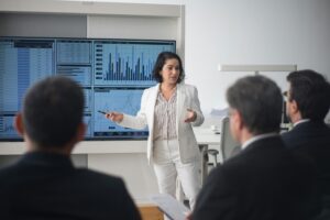 Woman presenting telecom data charts for marketing