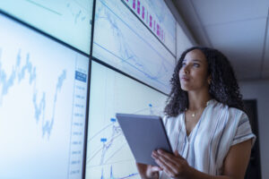 A customer acquisition strategist looking at graphs on the wall